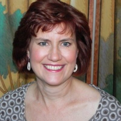 Headshot of Erin Armstrong, Vice President of Marketing, Communication, and Digital Media at the Franklin Institute in Philadelphia. She is a middle-aged woman with red hair, and is smiling.